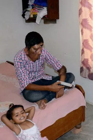 Bhupinder Singh watching TV with his sister